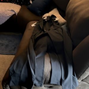 Black pantsuit, top is long and has a split in the back